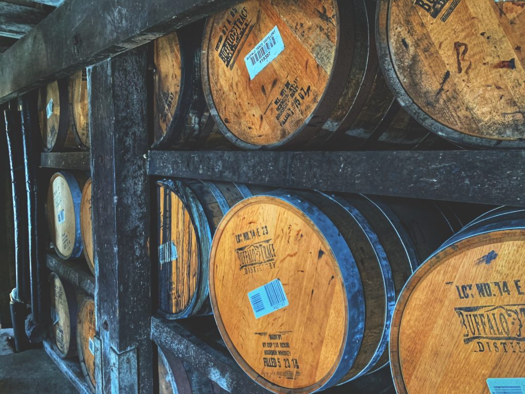 brown wooden barrels on wooden barrels